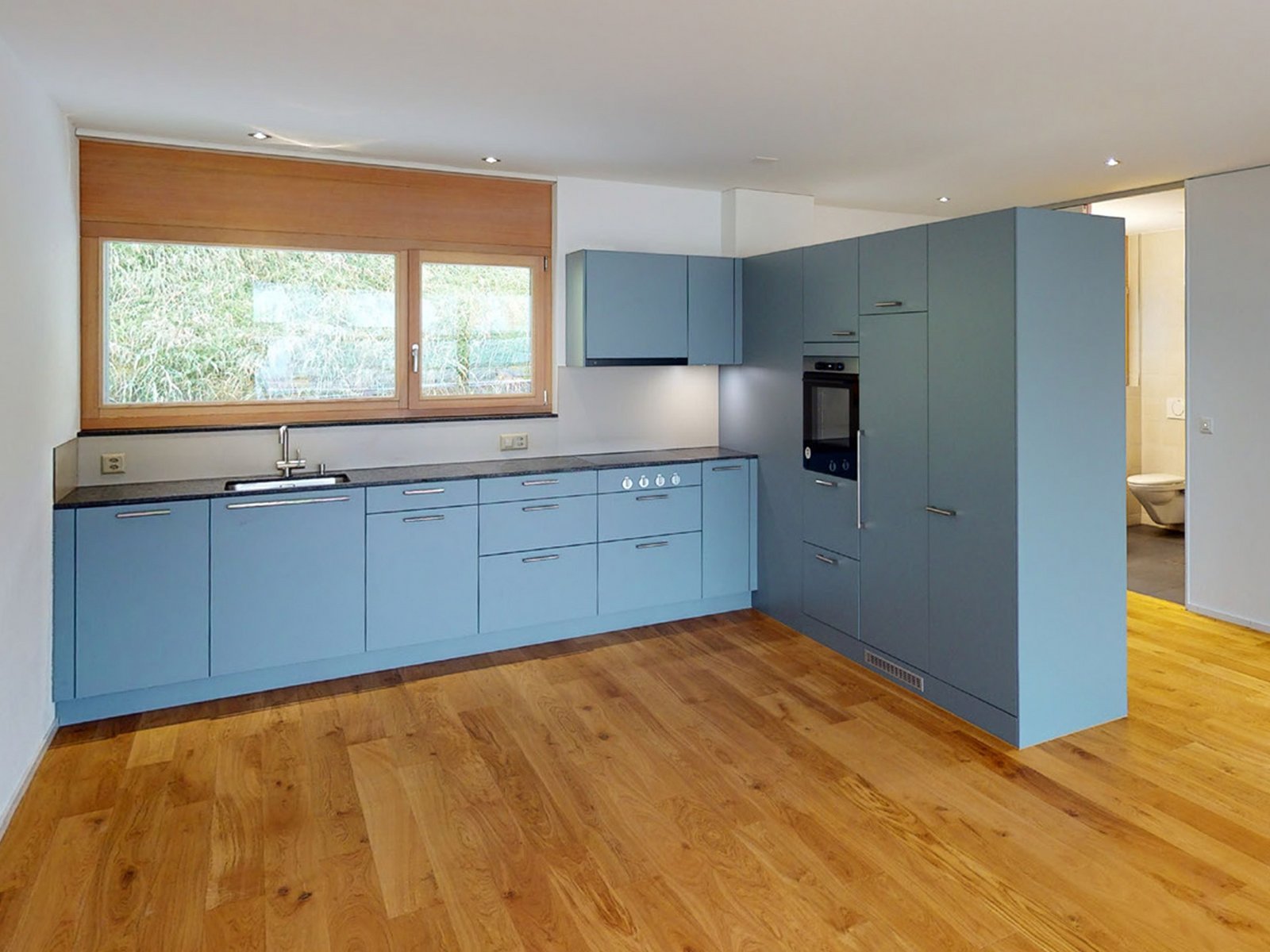 Eine moderne Wohnung mit blauer Küche an der Gartenstrasse in Neuenegg
